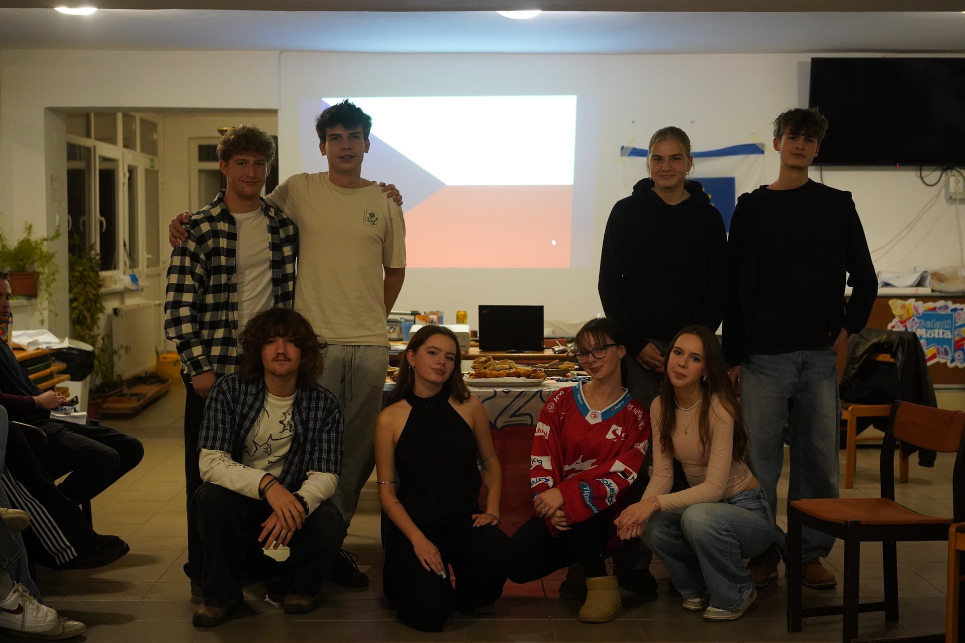Our Czech team at their cultural night, the flag projected behind them
