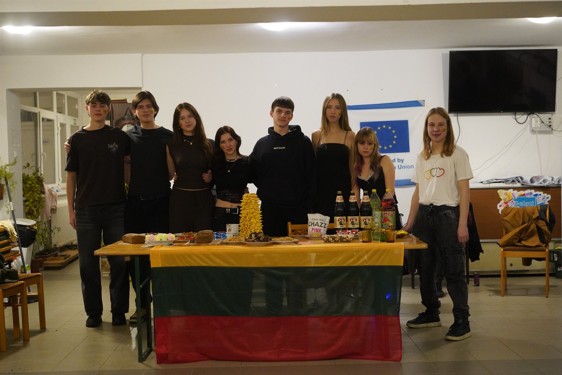 Our team at their Lithuanian cultural night behind the flag