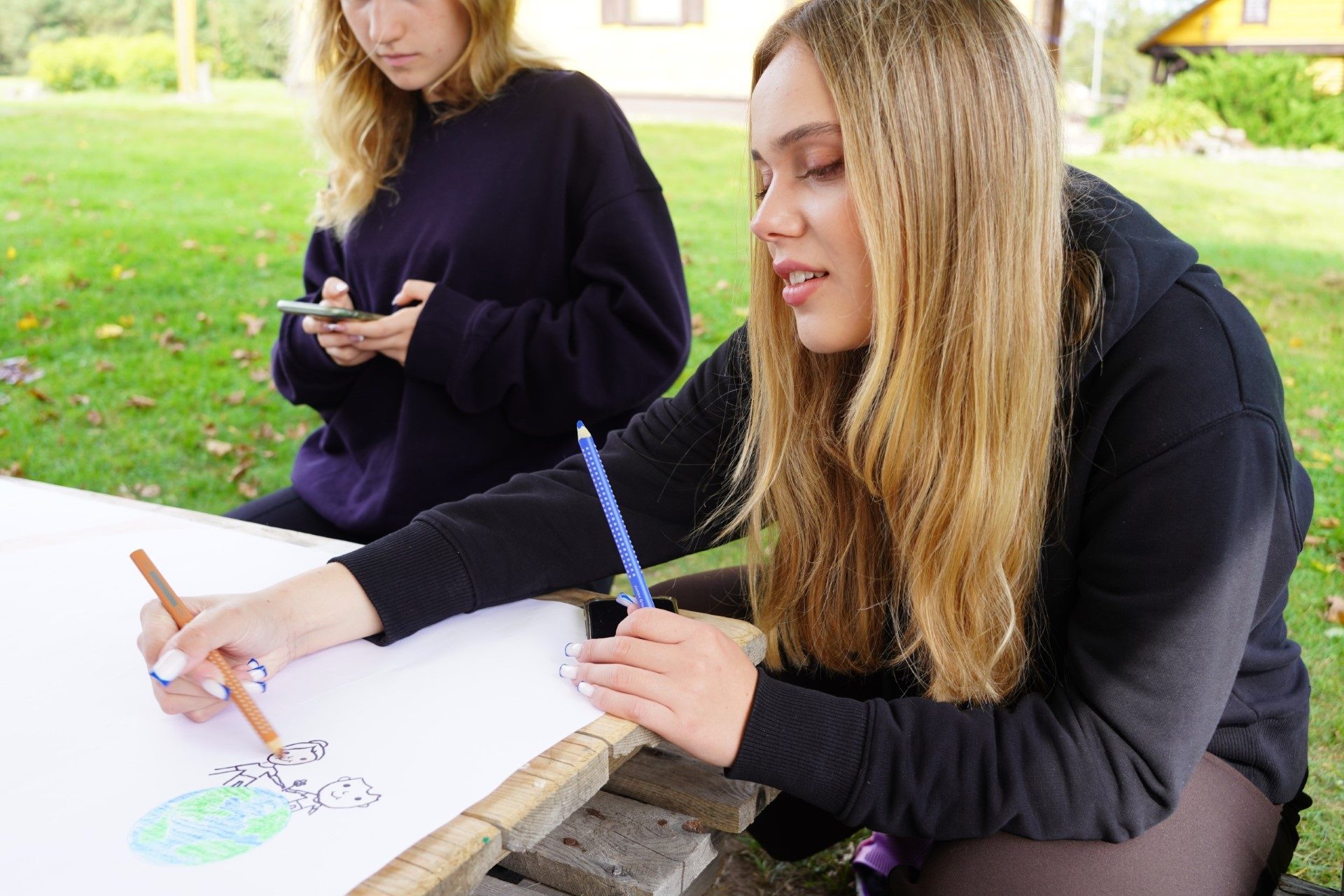 Working on a drawing together outdoors