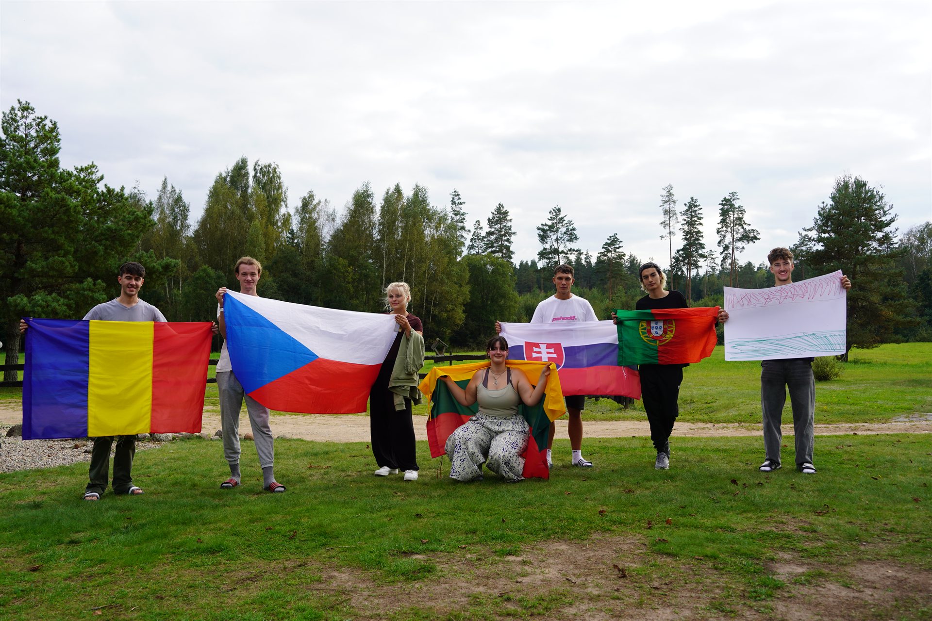 Participants raise the flags of the six countries that took part