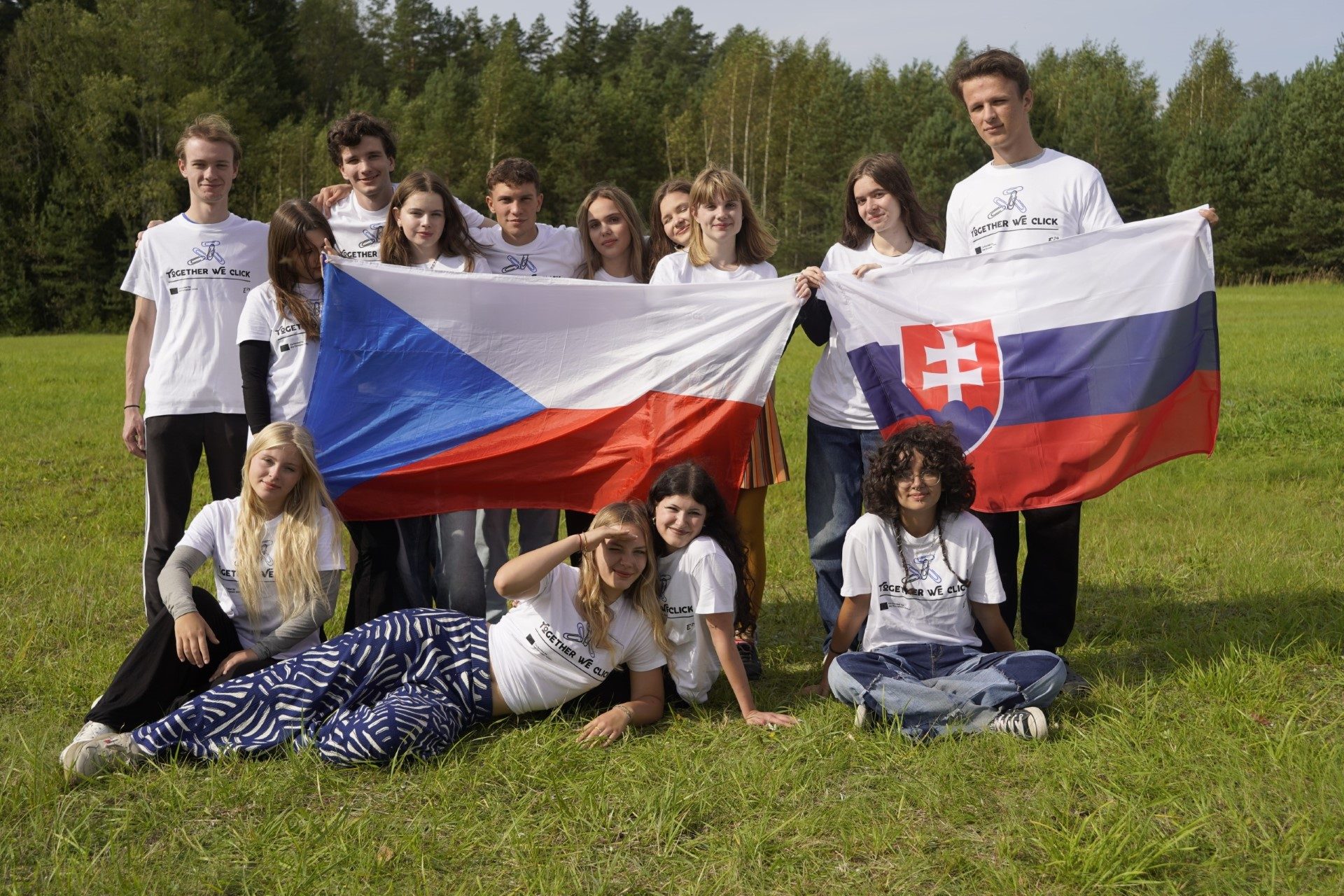 Participants hold up their national flags