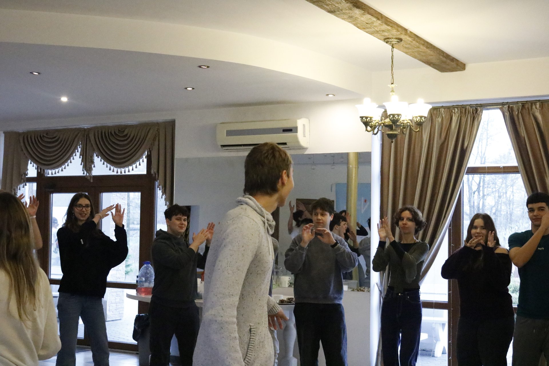 The group clapping together in the main hall