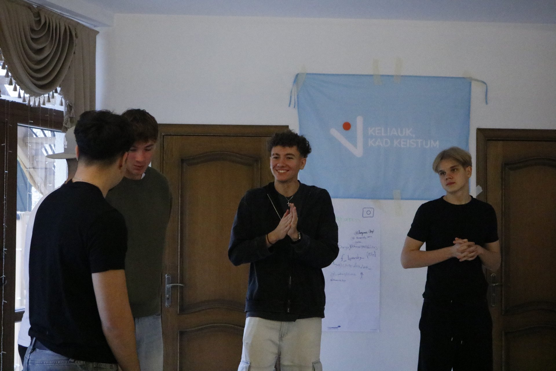 Participants presenting beside the project banner